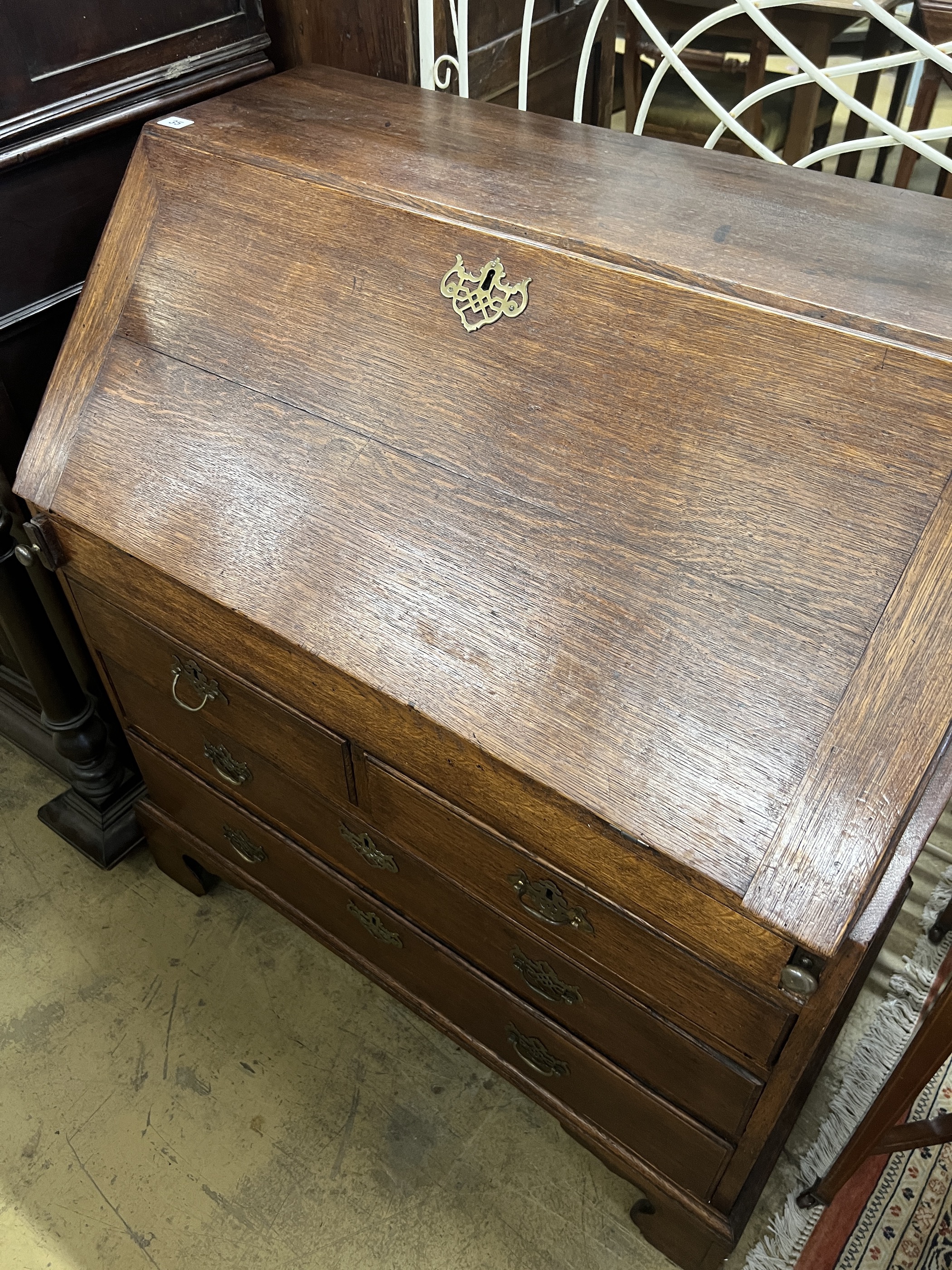 A George III oak bureau the interior with well, width 92cm, depth 53cm, height 101cm